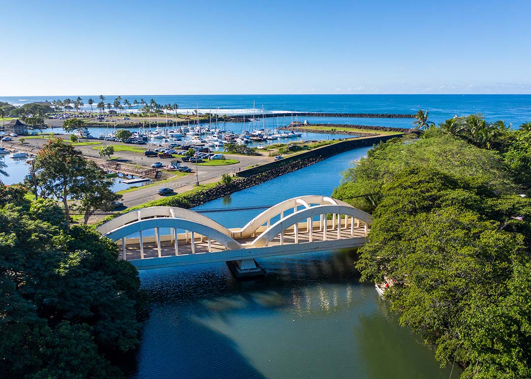 A drone shot of the Haleiwa bridge and harbor from above.
